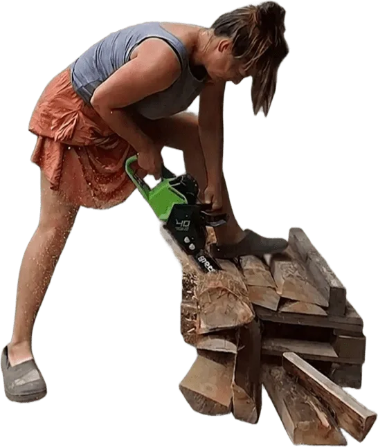 Žaneta Svozilová cutting a log with a chainsaw on the farm